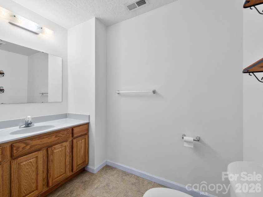 37 Leatherwood Drive, Candler, NC 28715.  MLS# CAR4376131, YatesRealty ID 25753. Lower-level half bath
