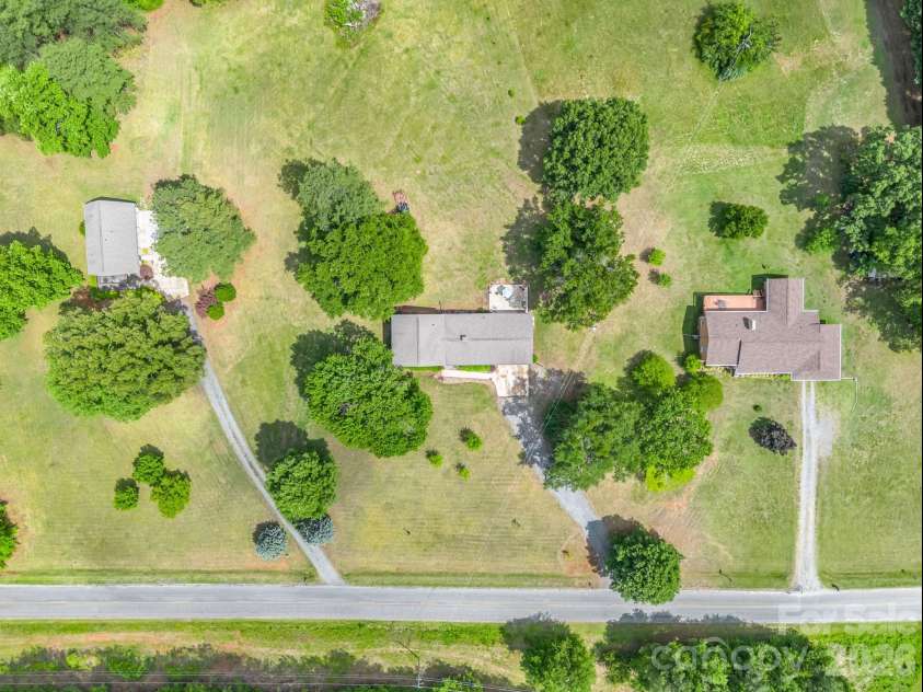 72 McEntire Road, Tryon, NC 28782.  MLS# CAR4411835, YatesRealty ID 25759. Middle house with back pasture