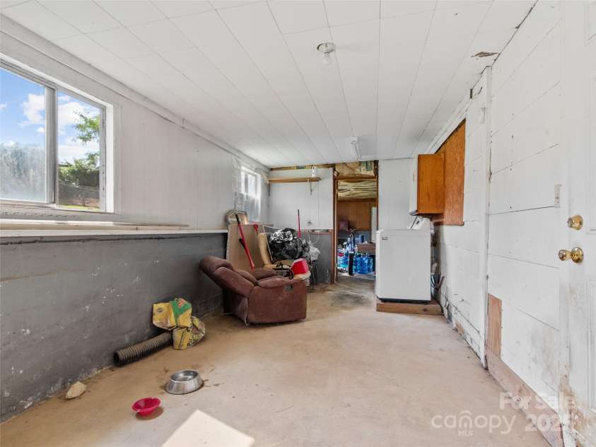 56 Love Fox Road, Burnsville, NC 28714.  MLS# CAR4277030, YatesRealty ID 25760. Back Storage area-- doggy door leading to fenced back yard.