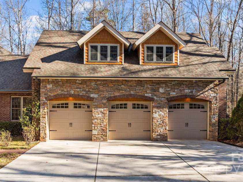 11280 Mcfalls Drive, Indian Land, SC 29707.  MLS# CAR4225880, YatesRealty ID 25762. # 3 car garage with additional RV parking pad to the right of garage in this image as well as a good look at the Engineered roof system.