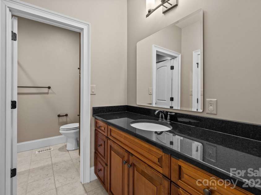 11280 Mcfalls Drive, Indian Land, SC 29707.  MLS# CAR4225880, YatesRealty ID 25762. A few highlights of this private full bath adjacent to the guest bedroom are the travertine flooring, beautiful cabinets and polished the granite countertop.