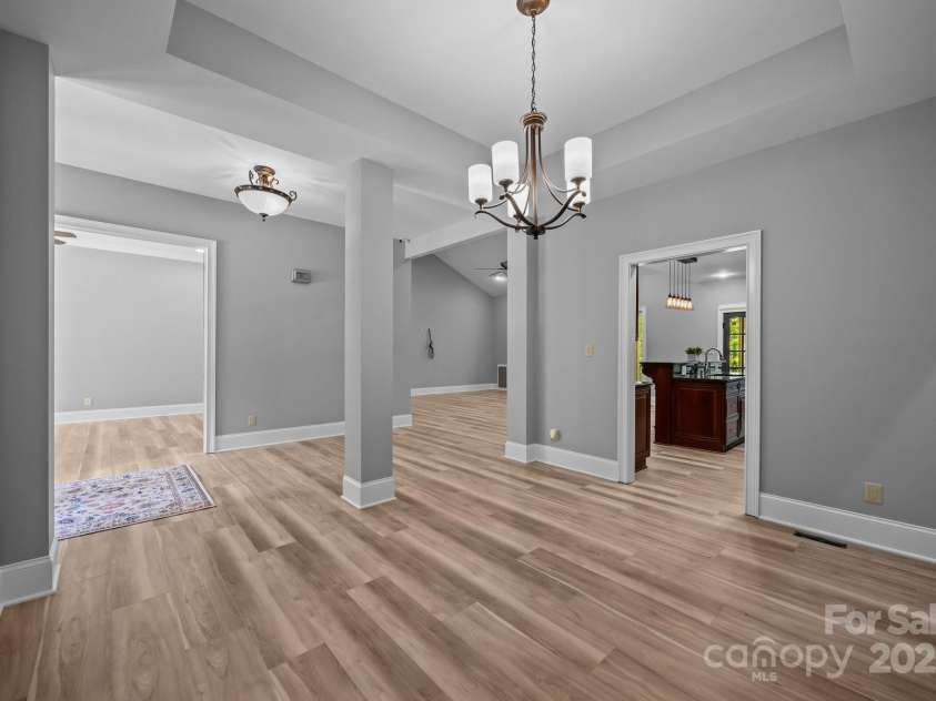 11280 Mcfalls Drive, Indian Land, SC 29707.  MLS# CAR4225880, YatesRealty ID 25762. Before and after picture showing new floors and paint in Dinning room.
