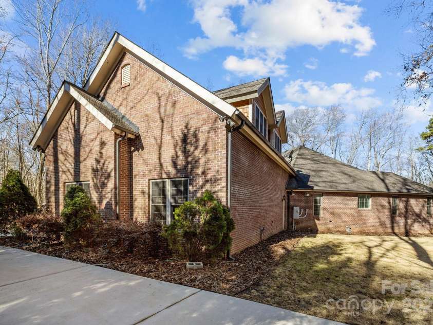 11280 Mcfalls Drive, Indian Land, SC 29707.  MLS# CAR4225880, YatesRealty ID 25762. The full brick home was designed with a special driveway so that you can park an RV on it's own pad shown here.