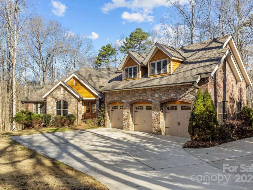 11280 Mcfalls Drive, Indian Land, SC 29707.  MLS# CAR4225880, YatesRealty ID 25762. This image showcases the raised elevation of the building footprint and scenic back drop of the estate. Take note the entire home is SPRAY FOAM INSULATED, the Attic is SEALED and the crawl space is SEALED and CONDTIO