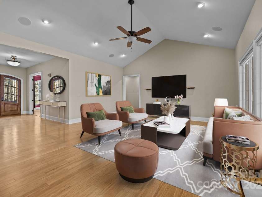 11280 Mcfalls Drive, Indian Land, SC 29707.  MLS# CAR4225880, YatesRealty ID 25762. This image shows the elegant main living area adjacent to the kitchen that features multiple seating areas,  all Bamboo flooring, a soaring cathedral ceiling and a large window suite that allows for overlooking the s