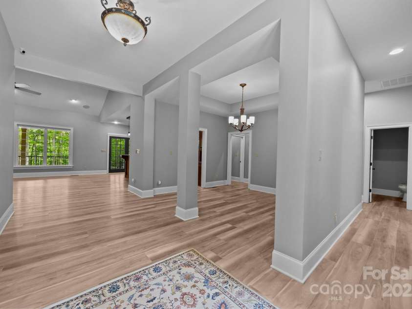 11280 Mcfalls Drive, Indian Land, SC 29707.  MLS# CAR4225880, YatesRealty ID 25762. Whole house New floors and paint and this image shows dinning room and look down into living room as well as pathway to stairwell leading to upper level.