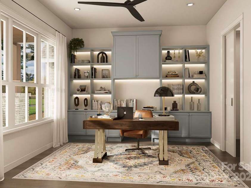 Lot 4 Country Estates Drive, Waxhaw, NC 28173.  MLS# CAR4278303, YatesRealty ID 25767. This beautifully designed home office features custom built-ins with soft blue cabinetry, warm accent lighting, and open shelving for stylish storage and display.