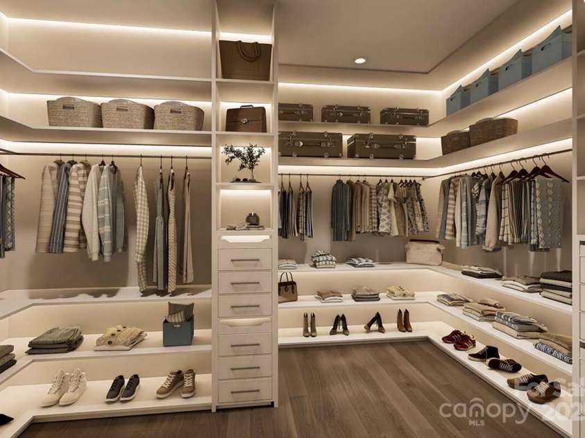 Lot 4 Country Estates Drive, Waxhaw, NC 28173.  MLS# CAR4278303, YatesRealty ID 25767. This expansive walk-in closet offers a boutique-style layout with custom built-ins, open shelving, and ample hanging space for effortless organization.