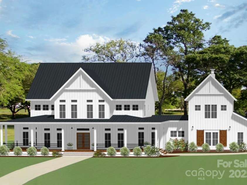 Lot 5 Country Estates Drive, Waxhaw, NC 28173.  MLS# CAR4278674, YatesRealty ID 25768. Stunning modern farmhouse features crisp white board-and-batten siding, a sleek black metal roof, charming wood-accented double doors. Full-front porch/expansive windows offer seamless indoor-outdoor living!