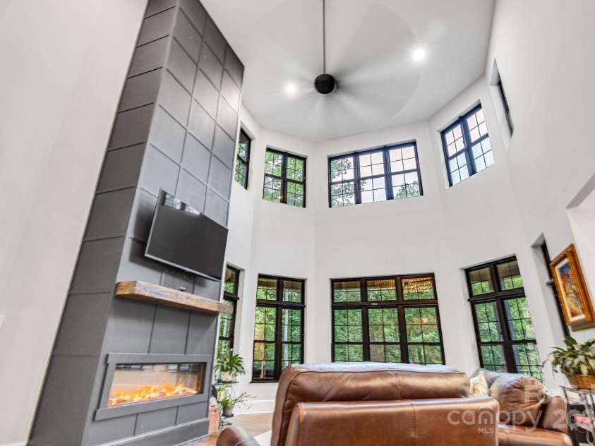 6327 Fox Tail Lane, Davidson, NC 28036.  MLS# CAR4271331, YatesRealty ID 25803. 2-Story great room with electric insert fireplace, and tinted windows looking onto the back yard.