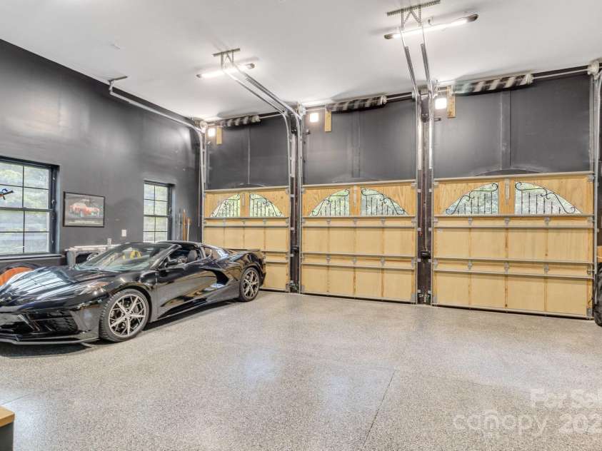 6327 Fox Tail Lane, Davidson, NC 28036.  MLS# CAR4271331, YatesRealty ID 25803. 3-Car garage with custom built doors, epoxy flooring and 13.5' ceiling.