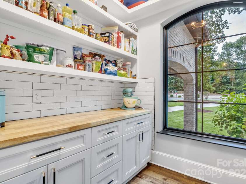 6327 Fox Tail Lane, Davidson, NC 28036.  MLS# CAR4271331, YatesRealty ID 25803. Built in cabinets and shelves provide lots of storage space in the walk-in pantry.