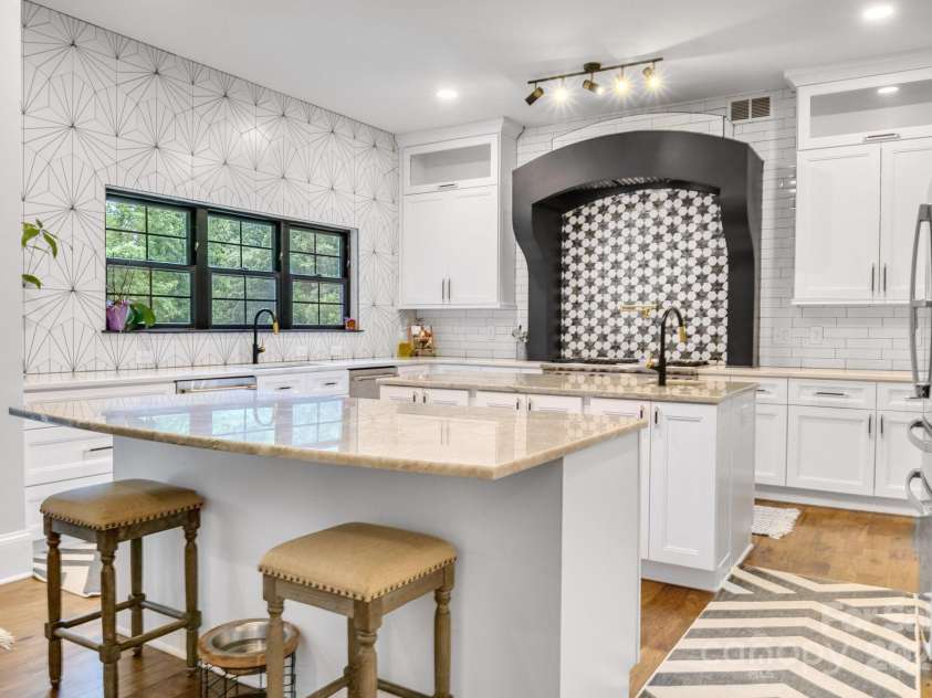 6327 Fox Tail Lane, Davidson, NC 28036.  MLS# CAR4271331, YatesRealty ID 25803. Large gourmet kitchen with two islands, double dishwashers and commercial grade range hood fan.