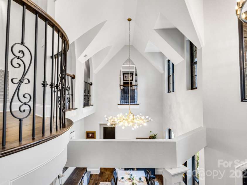 6327 Fox Tail Lane, Davidson, NC 28036.  MLS# CAR4271331, YatesRealty ID 25803. Overlooking the dining room from the spiral staircase