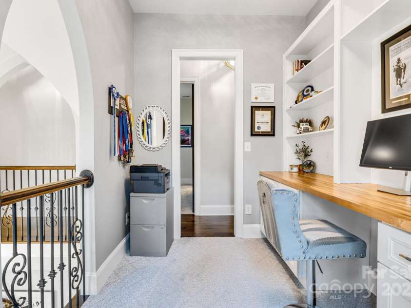 6327 Fox Tail Lane, Davidson, NC 28036.  MLS# CAR4271331, YatesRealty ID 25803. Second floor office with Juliet balcony overlooks the dining room below. Custom cabinets and shelves provide lots of work and storage space.