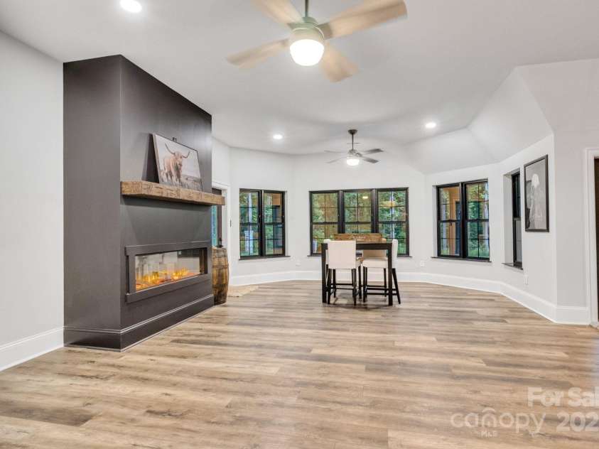 6327 Fox Tail Lane, Davidson, NC 28036.  MLS# CAR4271331, YatesRealty ID 25803. Spacious rec room with electric fireplace insert, provides dual access to the backyard.