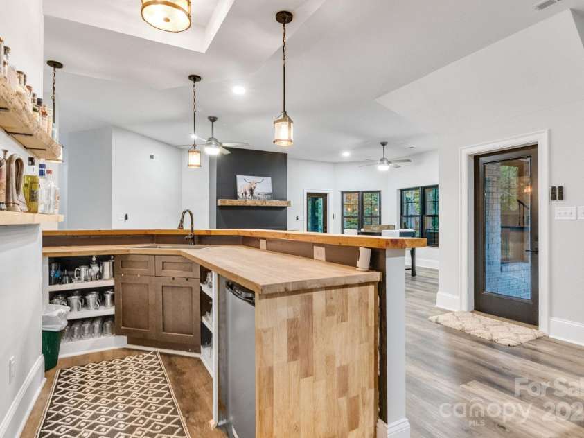6327 Fox Tail Lane, Davidson, NC 28036.  MLS# CAR4271331, YatesRealty ID 25803. Wet bar has ample storage and custom built-ins.