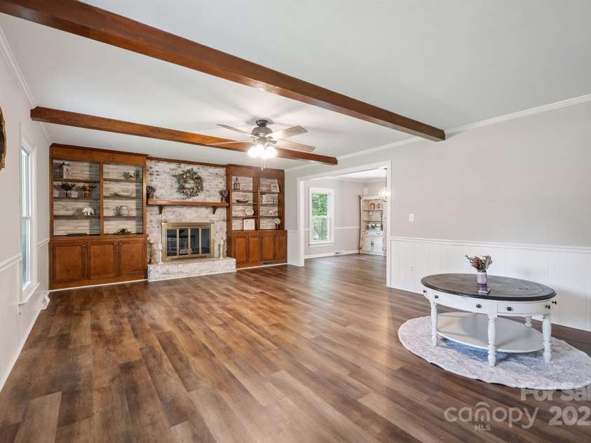 10206 Washam Potts Road, Cornelius, NC 28031.  MLS# CAR4273009, YatesRealty ID 25825. Living Room with fireplace and built-in bookshelves and storage