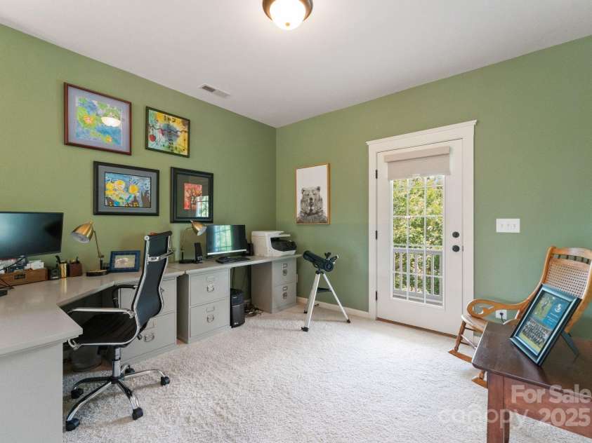 5137 Rialto Street, Belmont, NC 28012.  MLS# CAR4277416, YatesRealty ID 25831. Currently configured as a stylish office, this versatile upstairs room offers the flexibility to serve as a recreational space or a cozy den. French doors open gracefully to a covered porch, providing a seamless indoor-ou