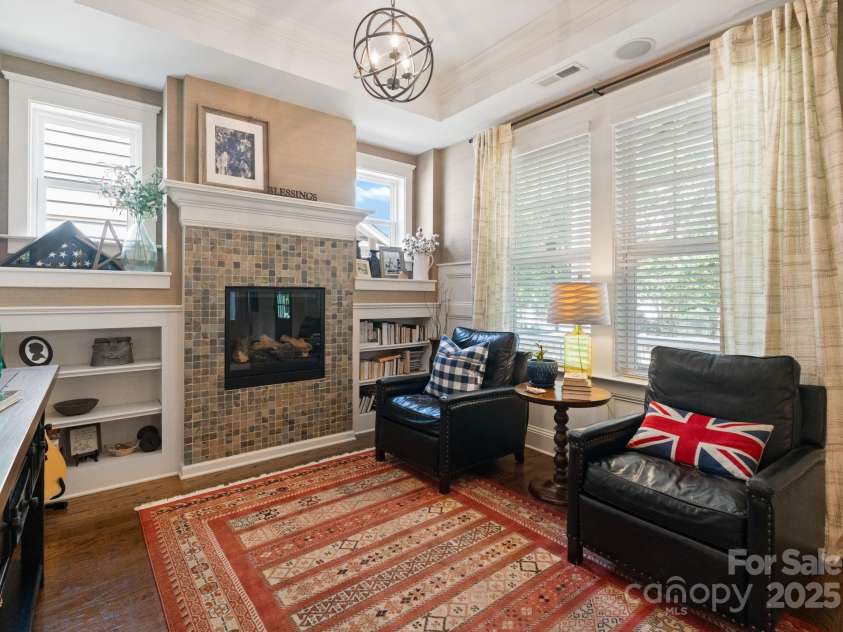 5137 Rialto Street, Belmont, NC 28012.  MLS# CAR4277416, YatesRealty ID 25831. Step into the formal living area, a refined space designed for both comfort and style. Centered around a beautiful gas fireplace, the room exudes warmth and sophistication, perfect for intimate gatherings or quiet evening