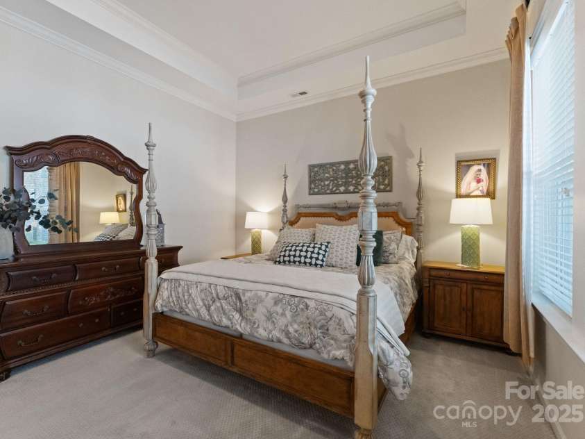 5137 Rialto Street, Belmont, NC 28012.  MLS# CAR4277416, YatesRealty ID 25831. The expansive primary bedroom offers a tranquil retreat, designed to evoke a sense of peace and calm through its sophisticated modern elegance. Soaring ceilings and abundant natural light create an airy, open ambiance, wh