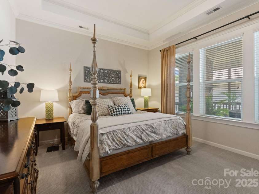 5137 Rialto Street, Belmont, NC 28012.  MLS# CAR4277416, YatesRealty ID 25831. The expansive primary bedroom unfolds like a peaceful haven, where light dances softly across soaring ceilings and serene spaces invite quiet reflection. Thoughtfully crafted with refined finishes and graceful modern line