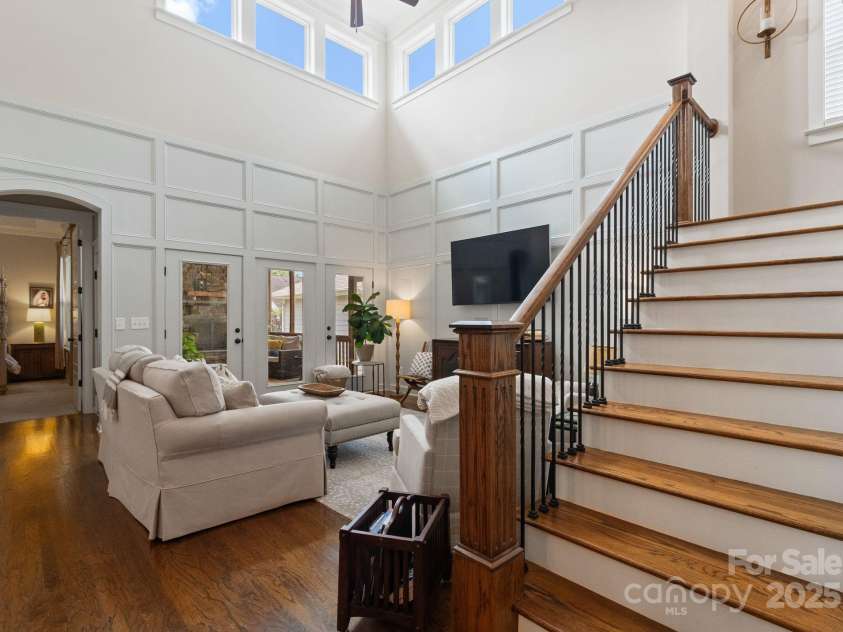 5137 Rialto Street, Belmont, NC 28012.  MLS# CAR4277416, YatesRealty ID 25831. The grand great room is an impressive space, anchored by soaring two-story ceilings adorned with additional windows at the upper level that flood the room with natural light. Elegant French doors open seamlessly to the sc