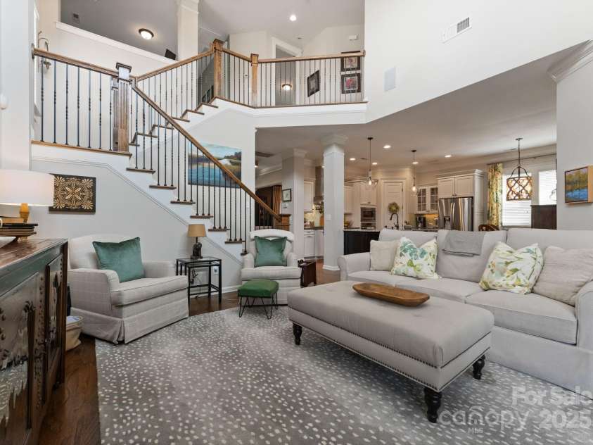 5137 Rialto Street, Belmont, NC 28012.  MLS# CAR4277416, YatesRealty ID 25831. The grand great room serves as the elegant centerpiece of the home, featuring soaring ceilings and an abundance of natural light that imbue the space with an airy and refined ambiance. A gracefully sculpted staircase asce