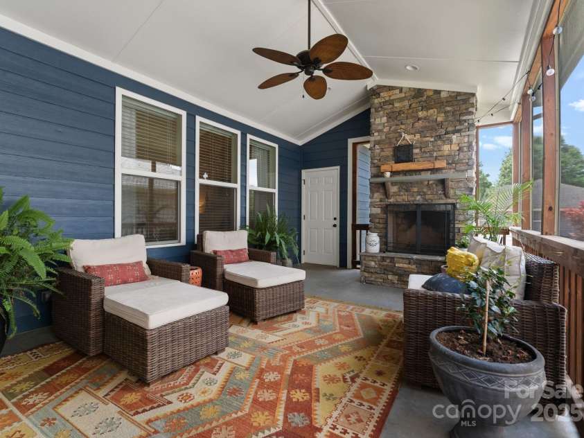 5137 Rialto Street, Belmont, NC 28012.  MLS# CAR4277416, YatesRealty ID 25831. The spacious screened porch, complete with a cozy wood-burning fireplace, is an entertainer’s dream—offering a seamless blend of indoor comfort and outdoor charm. Open to the garage for effortless access, this versatile s