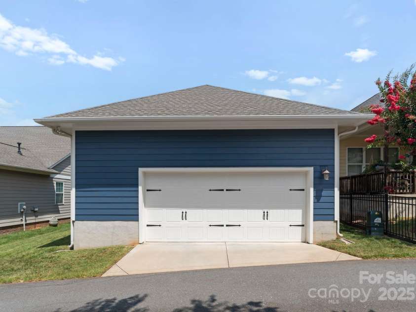 5137 Rialto Street, Belmont, NC 28012.  MLS# CAR4277416, YatesRealty ID 25831. The two-car garage is discreetly positioned at the rear of the home, offering convenient access from a quiet street. Thoughtfully integrated into the home’s architecture, the exterior showcases refined detailing and cohes