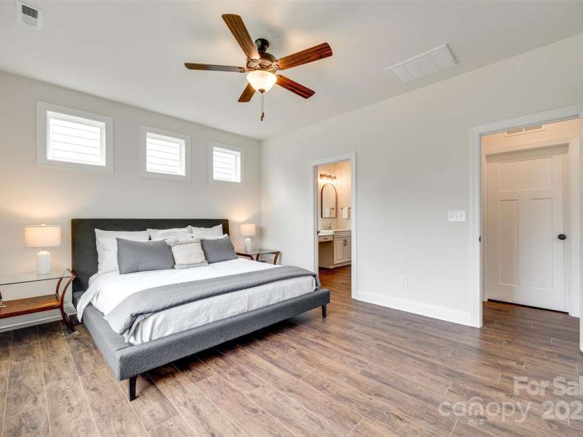 18011 Wilbanks Drive, Charlotte, NC 28278.  MLS# CAR4256574, YatesRealty ID 25857. A serene main-level retreat with oversized windows and elevated ceilings—your personal sanctuary awaits.