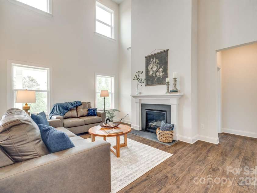 18011 Wilbanks Drive, Charlotte, NC 28278.  MLS# CAR4256574, YatesRealty ID 25857. Bathed in light with elevated windows and a beautiful fireplace centerpiece—this space makes a statement.