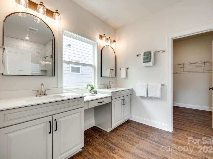 18011 Wilbanks Drive, Charlotte, NC 28278.  MLS# CAR4256574, YatesRealty ID 25857. Dual vanities with plenty of counter space and a dedicated makeup station—style meets function.