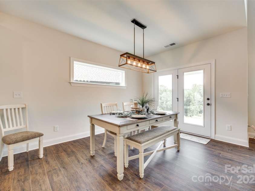 18011 Wilbanks Drive, Charlotte, NC 28278.  MLS# CAR4256574, YatesRealty ID 25857. Gather in style—this elegant dining space offers natural light, high ceilings, and effortless flow to the kitchen and outdoor living.
