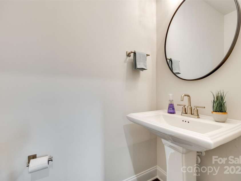 18011 Wilbanks Drive, Charlotte, NC 28278.  MLS# CAR4256574, YatesRealty ID 25857. Stylish half bath with pedestal sink and designer mirror.