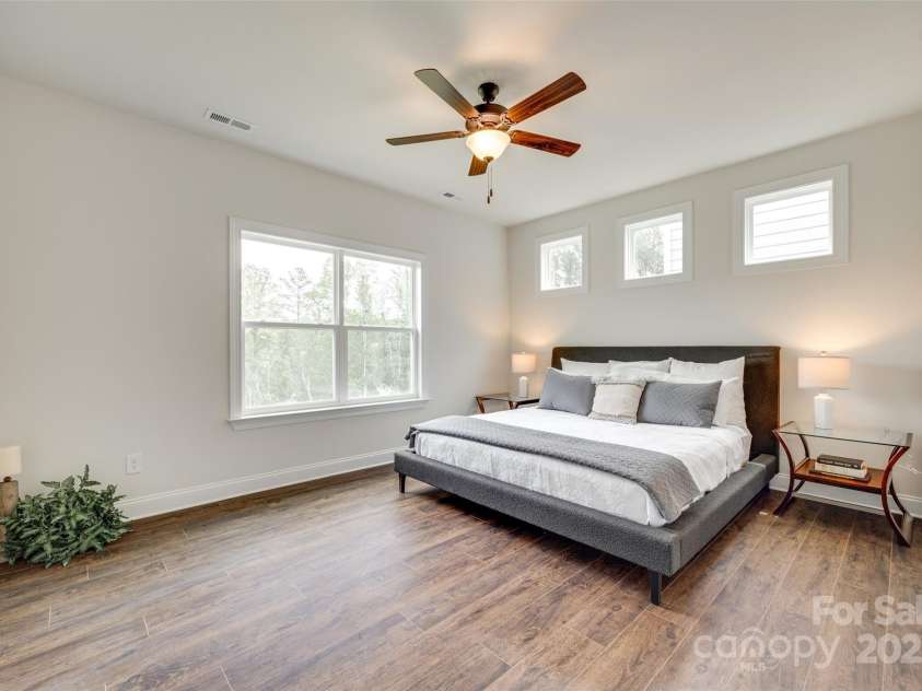 18011 Wilbanks Drive, Charlotte, NC 28278.  MLS# CAR4256574, YatesRealty ID 25857. The main-level primary suite offers elevated ceilings, modern style, and direct access to a spa-inspired bath.