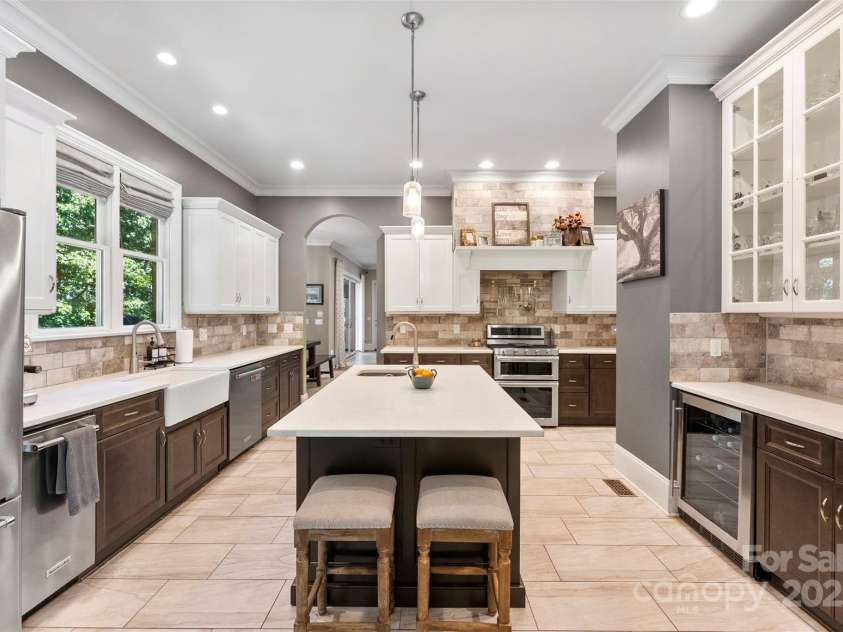 10007 Hillspring Drive, Huntersville, NC 28078.  MLS# CAR4272682, YatesRealty ID 25864. Gourmet custom kitchen featuring Quartz countertops, a stunning stone backsplash, dual wine/beverage fridges, and a dedicated ice maker