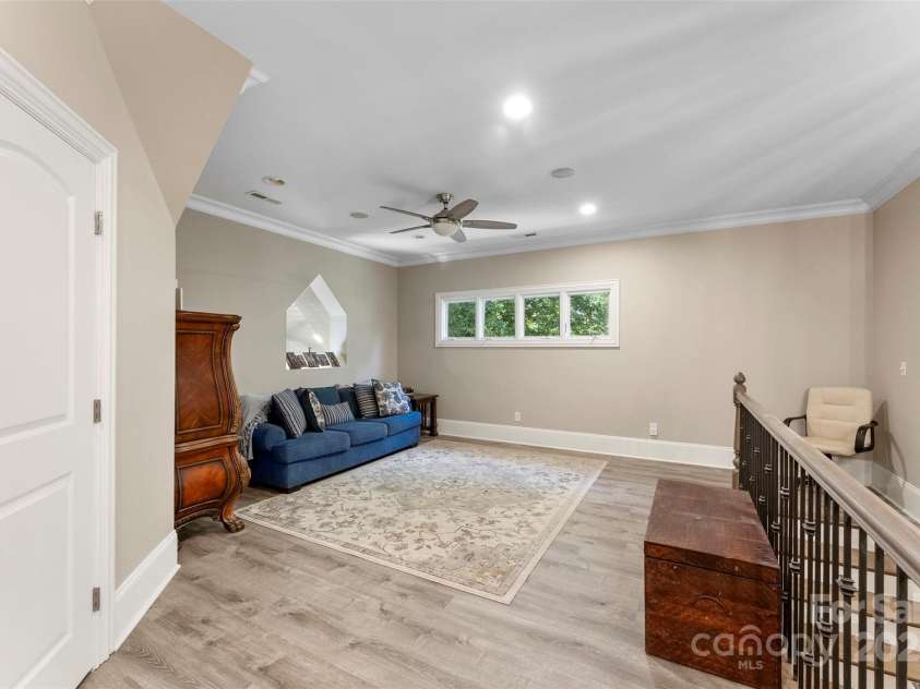 10007 Hillspring Drive, Huntersville, NC 28078.  MLS# CAR4272682, YatesRealty ID 25864. Upper-level loft offers flexible living space and overlooks the custom wood staircase with striking iron railings