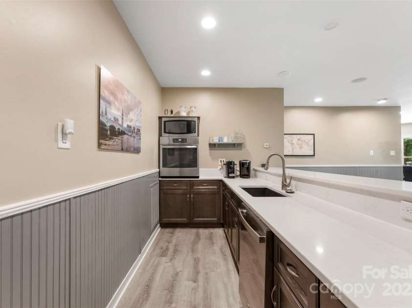 10007 Hillspring Drive, Huntersville, NC 28078.  MLS# CAR4272682, YatesRealty ID 25864. Wet bar area features, sink, ss fridge, quartz counters, dishwasher, convection oven, built in microwave & beverage fridge