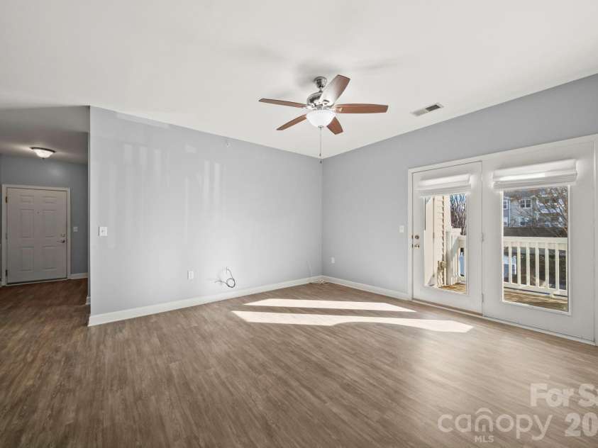 17113 Doe Valley Court, Cornelius, NC 28031.  MLS# CAR4331487, YatesRealty ID 25888. Family Room with exit to balcony