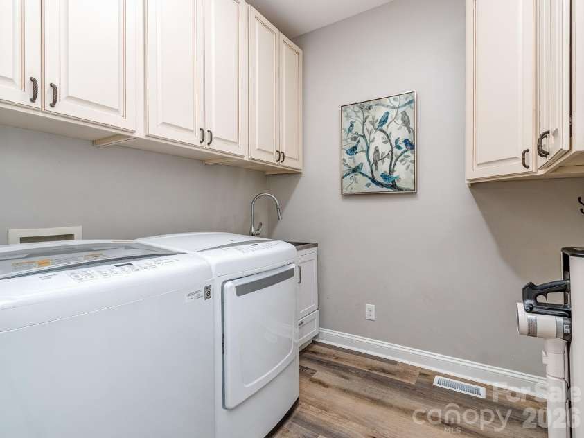 9205 Belmont Lane, Waxhaw, NC 28173.  MLS# CAR4381231, YatesRealty ID 25906. Laundry room with sink and cabinet storage