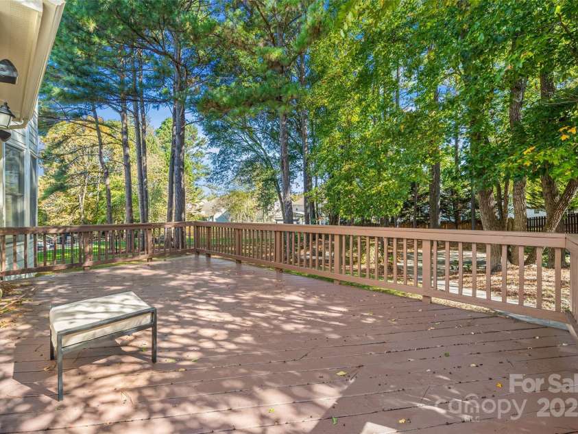7146 Harcourt Crossing, Indian Land, SC 29707.  MLS# CAR4313502, YatesRealty ID 25914. Large deck w/ gate overlooking the shady back yard