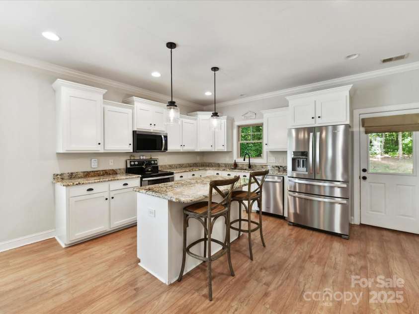 3801 Creek Ridge Drive, Denver, NC 28037.  MLS# CAR4258804, YatesRealty ID 25922. Spacious Kitchen features granite counters, brand new, upgraded, stainless steel appliances, island with seating/storage, upgraded lighting, painted white cabinets & pantry!