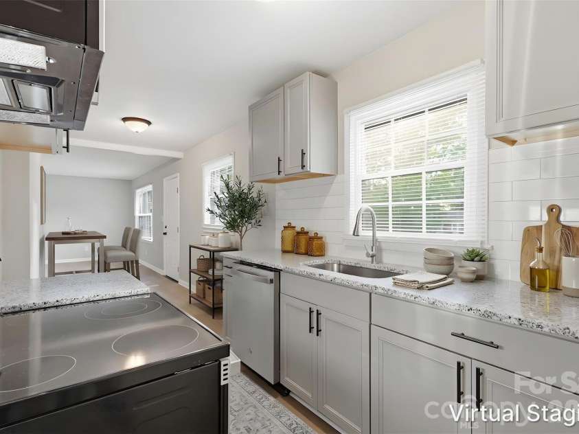 364 Leafmore Drive, Charlotte, NC 28213.  MLS# CAR4384246, YatesRealty ID 25936. Third shot of your updated kitchen!! Enhancements include granite counters, SS appliances (includes dishwasher, electric range & microwave), shaker-style cabinets, subway tile backsplash & SS dual deep sink (virtually s