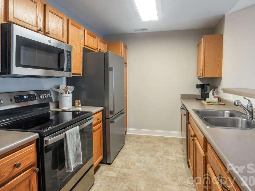 94 Foxden Drive, Fletcher, NC 28732.  MLS# CAR4364312, YatesRealty ID 25941. Spacious galley kitchen with ample storage