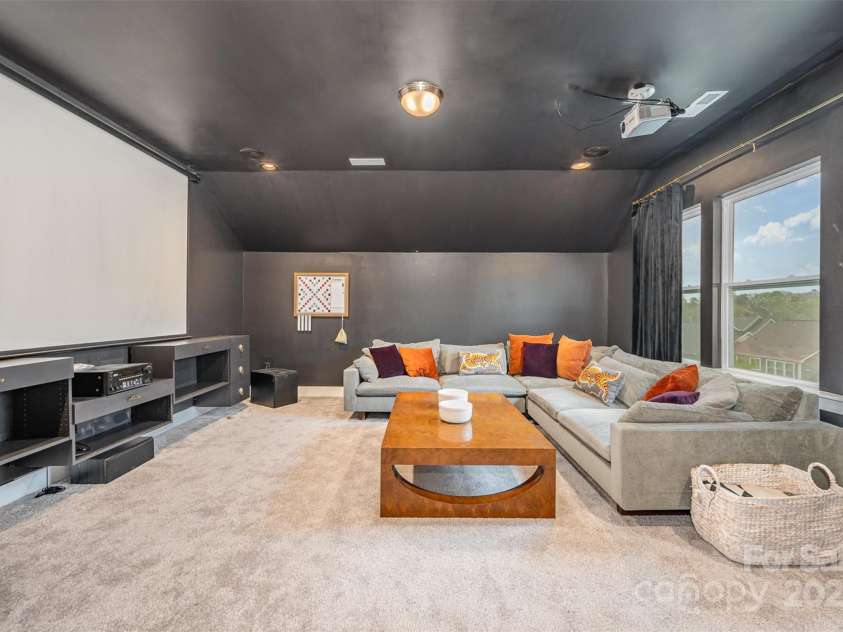 2332 Paddlers Cove Drive, Clover, SC 29710.  MLS# CAR4242429, YatesRealty ID 25958. 5th bedroom utilized as large theater room, built ins, wet bar and beverage refrigerator. In ceiling surround sound, projector and 100