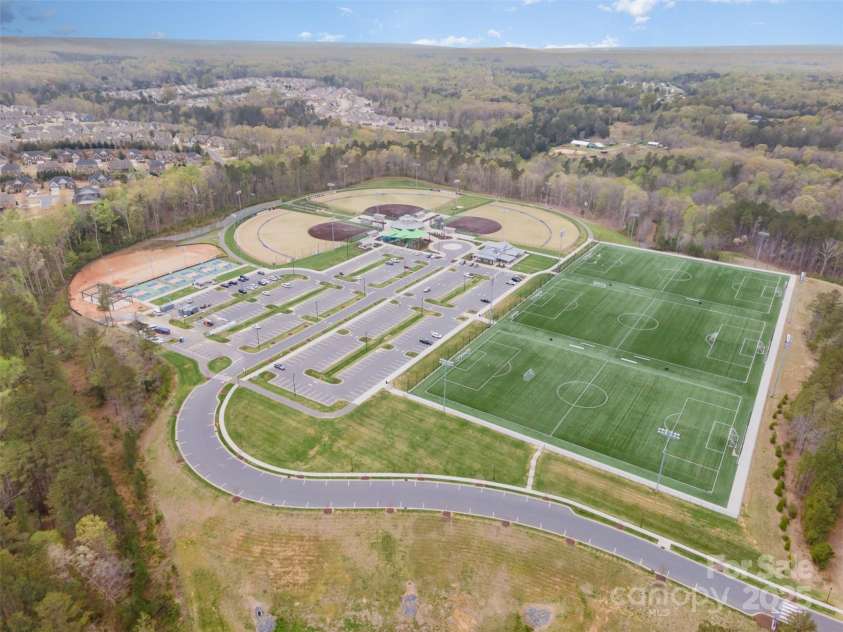 2332 Paddlers Cove Drive, Clover, SC 29710.  MLS# CAR4242429, YatesRealty ID 25958. Aerial view of Field Day Park with soccer fields, baseball fields, pickleball courts and large clubhouse that can be rented for special events through York County.