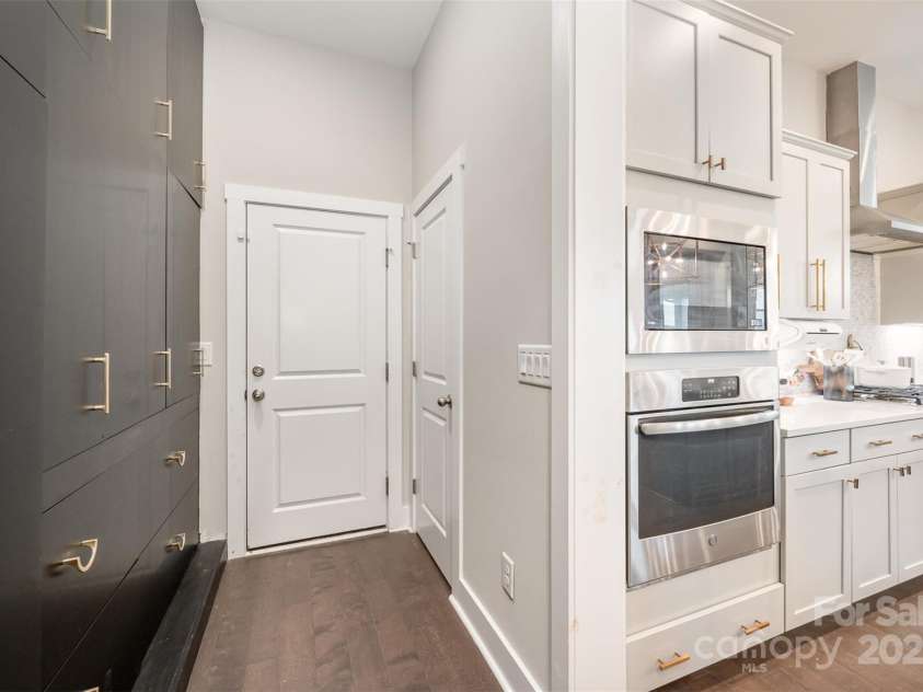 2332 Paddlers Cove Drive, Clover, SC 29710.  MLS# CAR4242429, YatesRealty ID 25958. Back hallway to garage, floor to ceiling custom built ins for maximum storage, walk in pantry with built ins for your Costco runs in addition to walk in pantry with custom shelving.