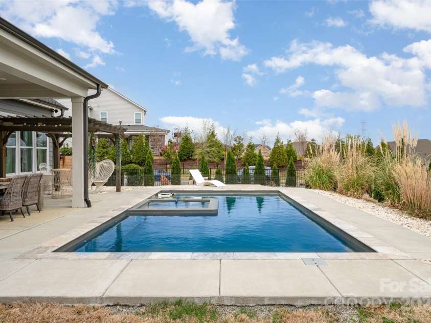2332 Paddlers Cove Drive, Clover, SC 29710.  MLS# CAR4242429, YatesRealty ID 25958. Backyard oasis with heated saltwater pool with tanning ledge and spa, privacy landscaping!