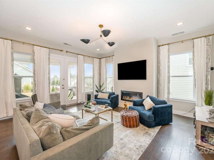 2332 Paddlers Cove Drive, Clover, SC 29710.  MLS# CAR4242429, YatesRealty ID 25958. Family room with linear gas fireplace and open floorplan, French doors to one of two covered patios for indoor/outdoor living!